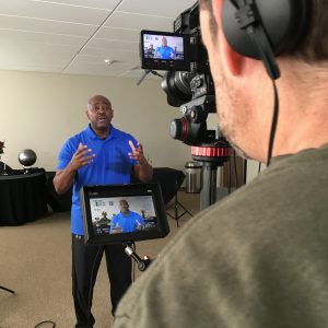 background, Filming, interview, blue, African-American, camera, inside, room, talking, man, monitor, film, view, watch, standing, story, tell your story, Visual Legacy Productions